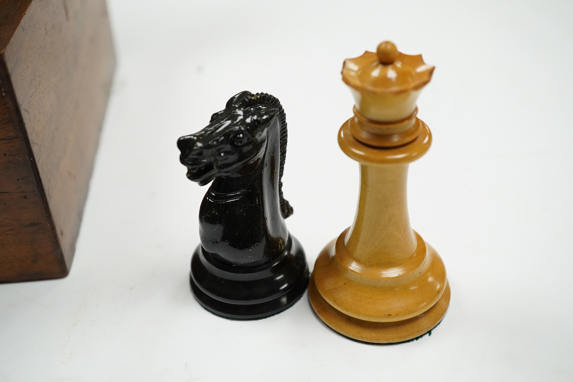 A boxed Jaques Staunton boxwood and ebonised lead weighted chess set, White king stamped Jaques London, Kings 10cm, unlabelled box 20cm wide x 9cm high. Condition - chess pieces good, box cracked